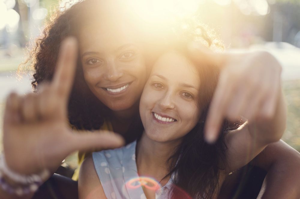 Two women smiling for a photo. 