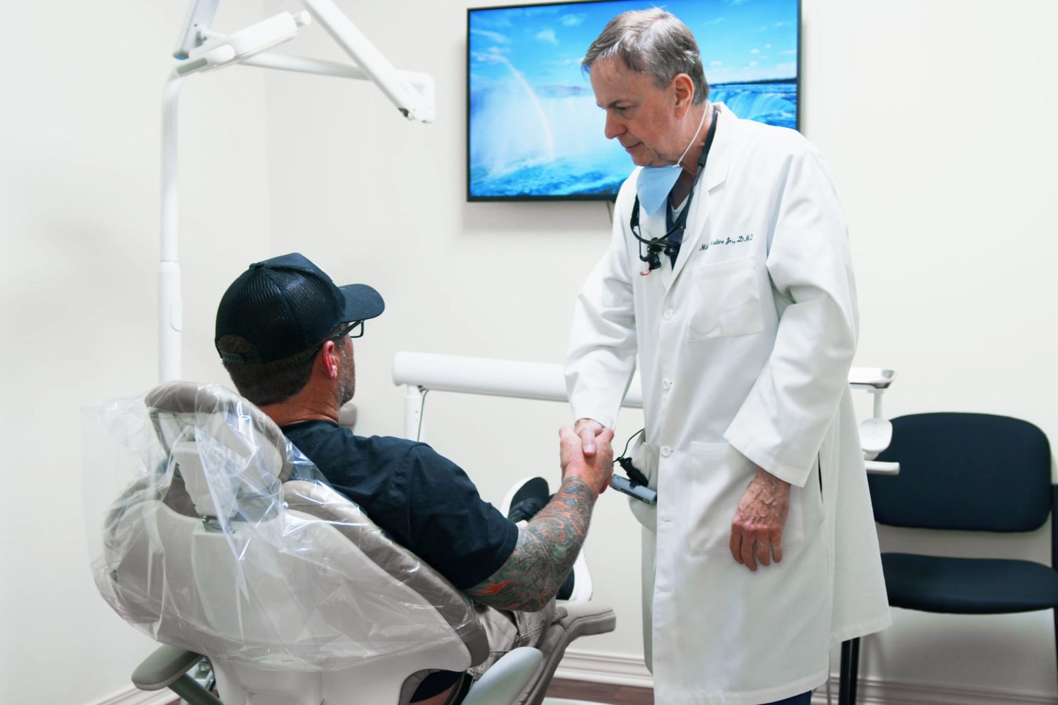 Dr. Maitre greeting a patient in the treatment chair at Maitre & Crabtree Dental Group in Mobile, AL